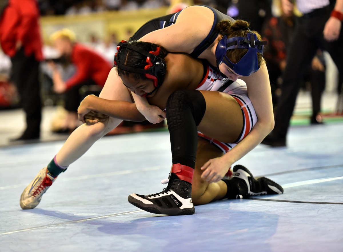 Edmond North's Bella Williams (top) wrestles during the Class 6A girls 140-pound weight class finals on Feb. 24, 2024. Williams got a pin to claim her second straight state title.